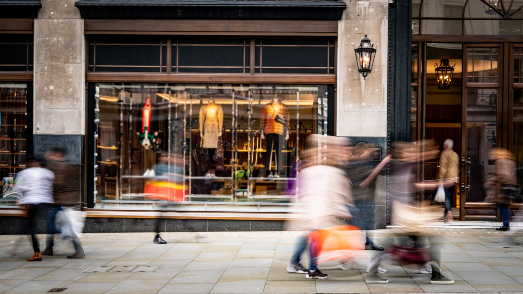 Motion blurred people walking on shopping street