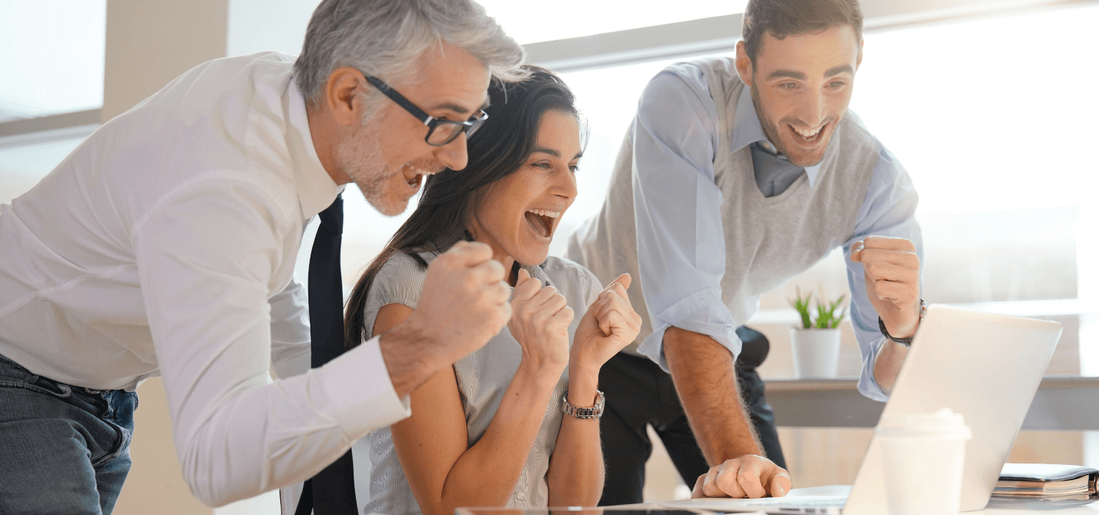 Happy teammates at a computer