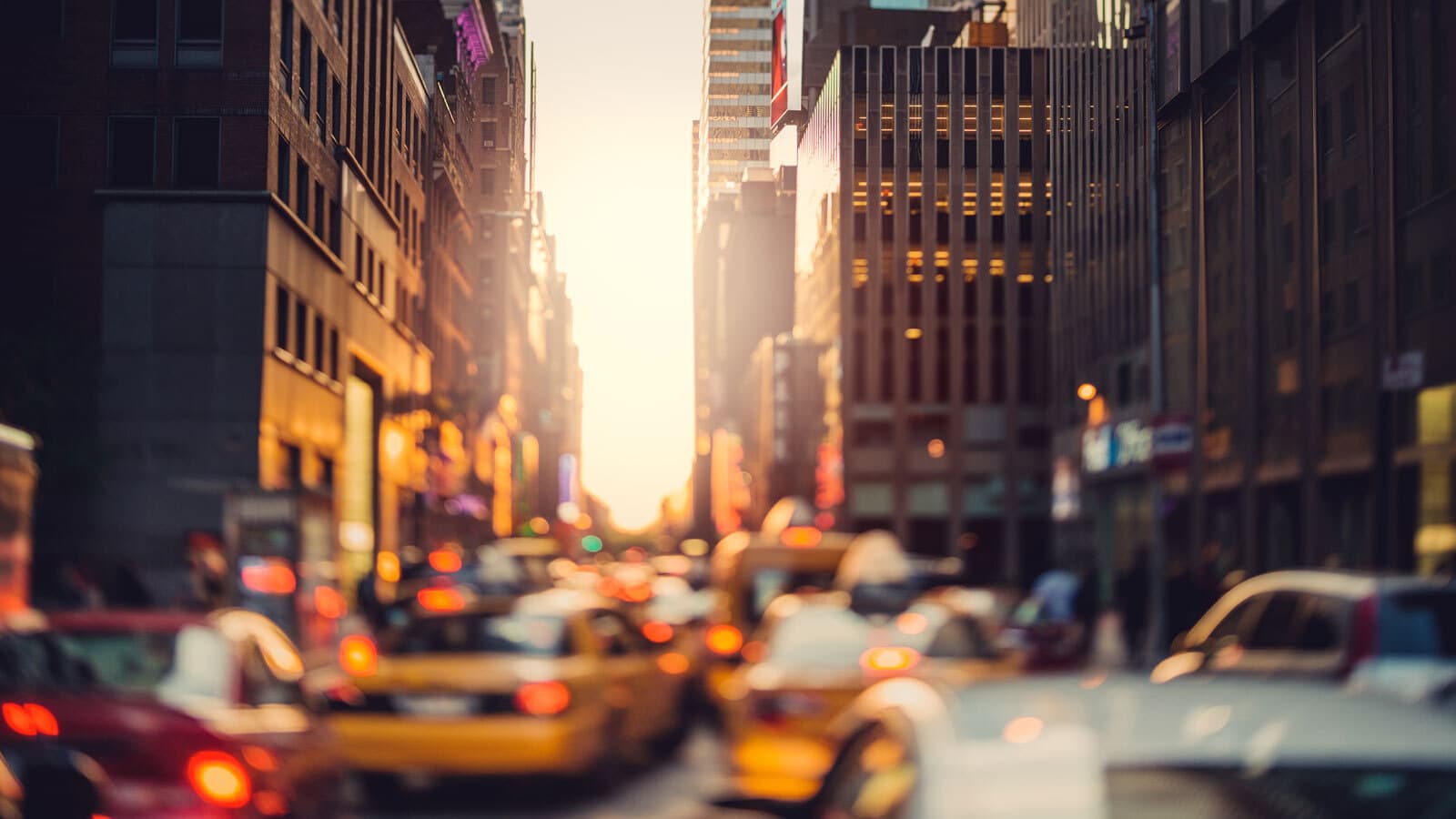 Blurred image of a city, cars and buildings.