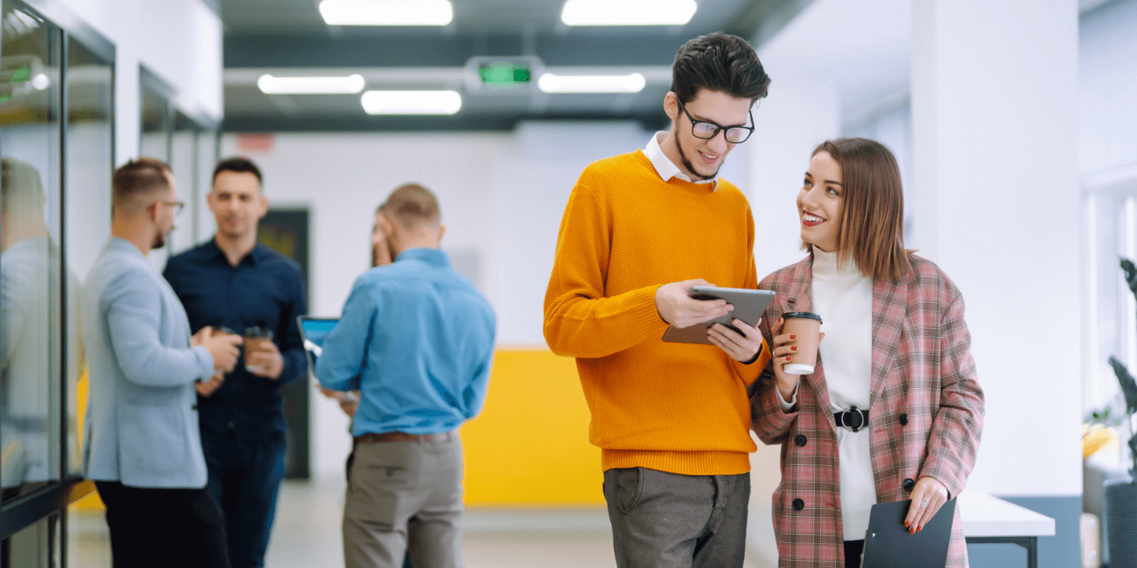 Two people collaborating in a hallway