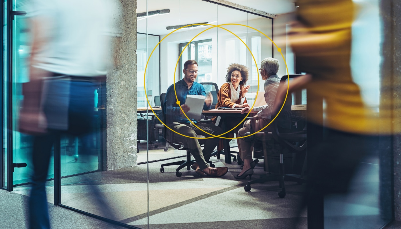 people smiling, in a business meeting, sitting