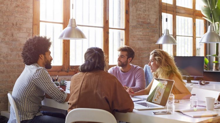 Four coworkers having a meeting in the office