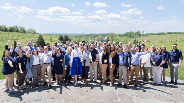 Team photo outside in front of a field