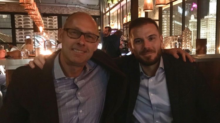 Two co-workers posing for a picture together at dinner