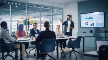 Man giving a presentation at a team meeting