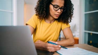 Woman wearing glasses using a laptop