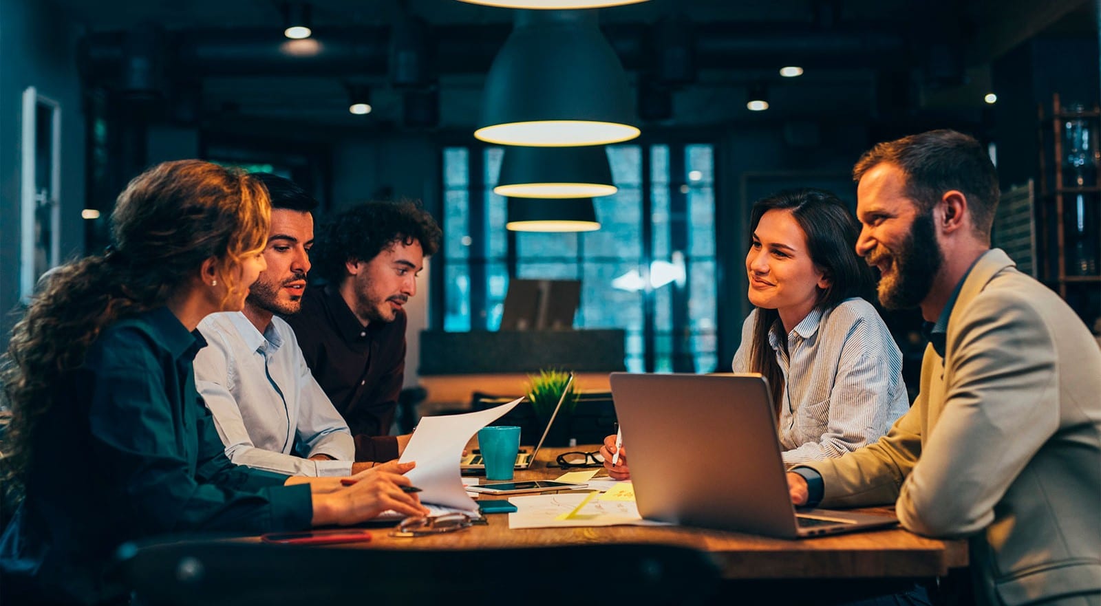 five people sitting and looking at each other