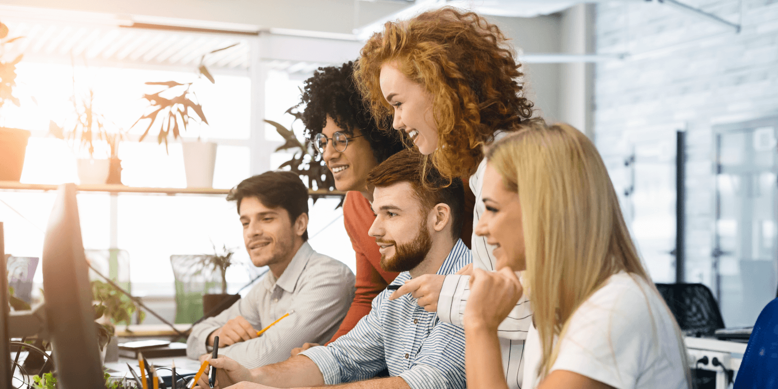 Group sitting around a computer