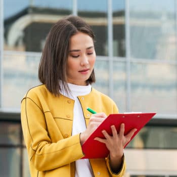 Woman writing on a red file