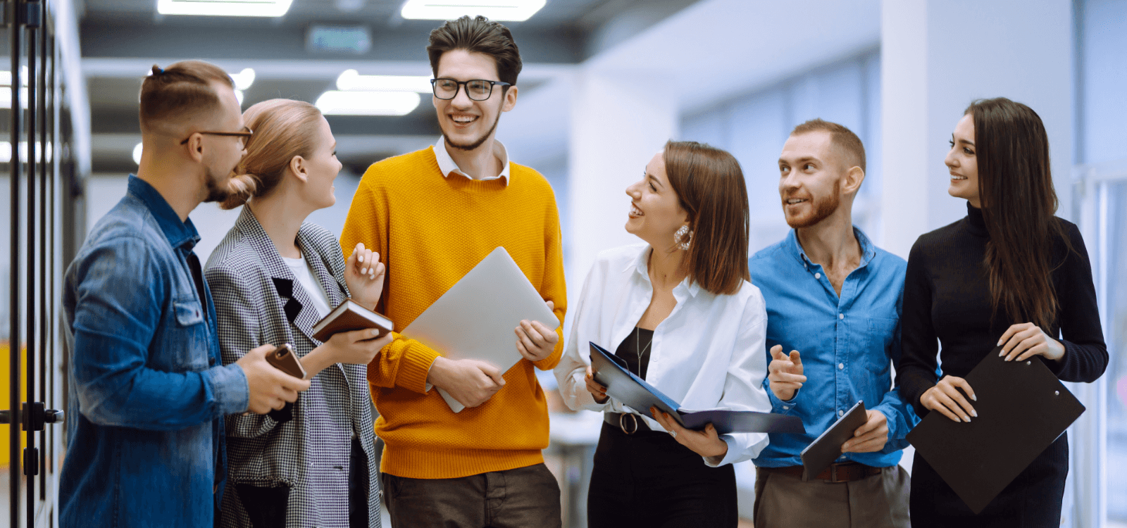 Team of people walking in an office hallway