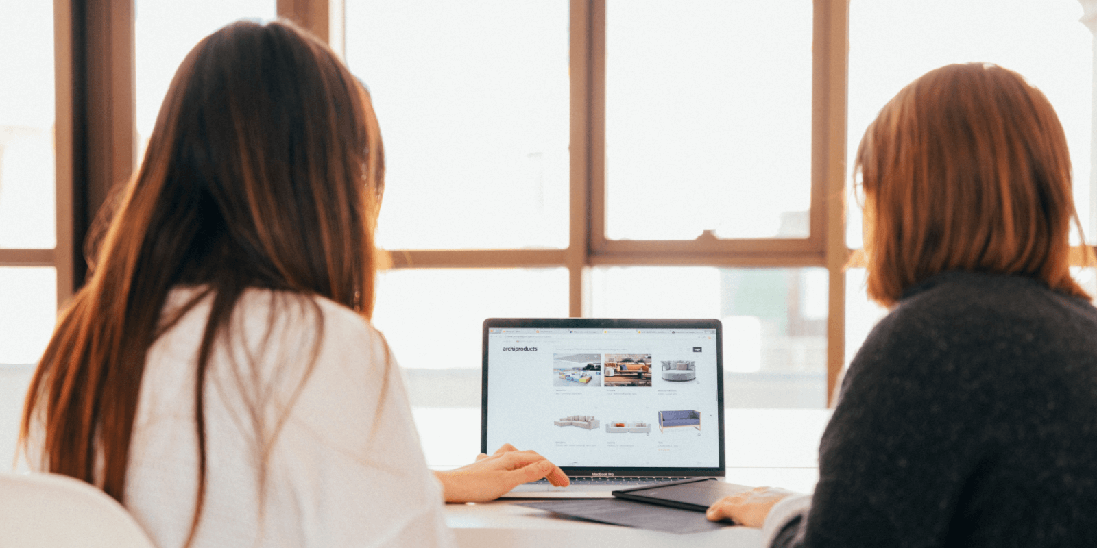 Two women looking at a laptop