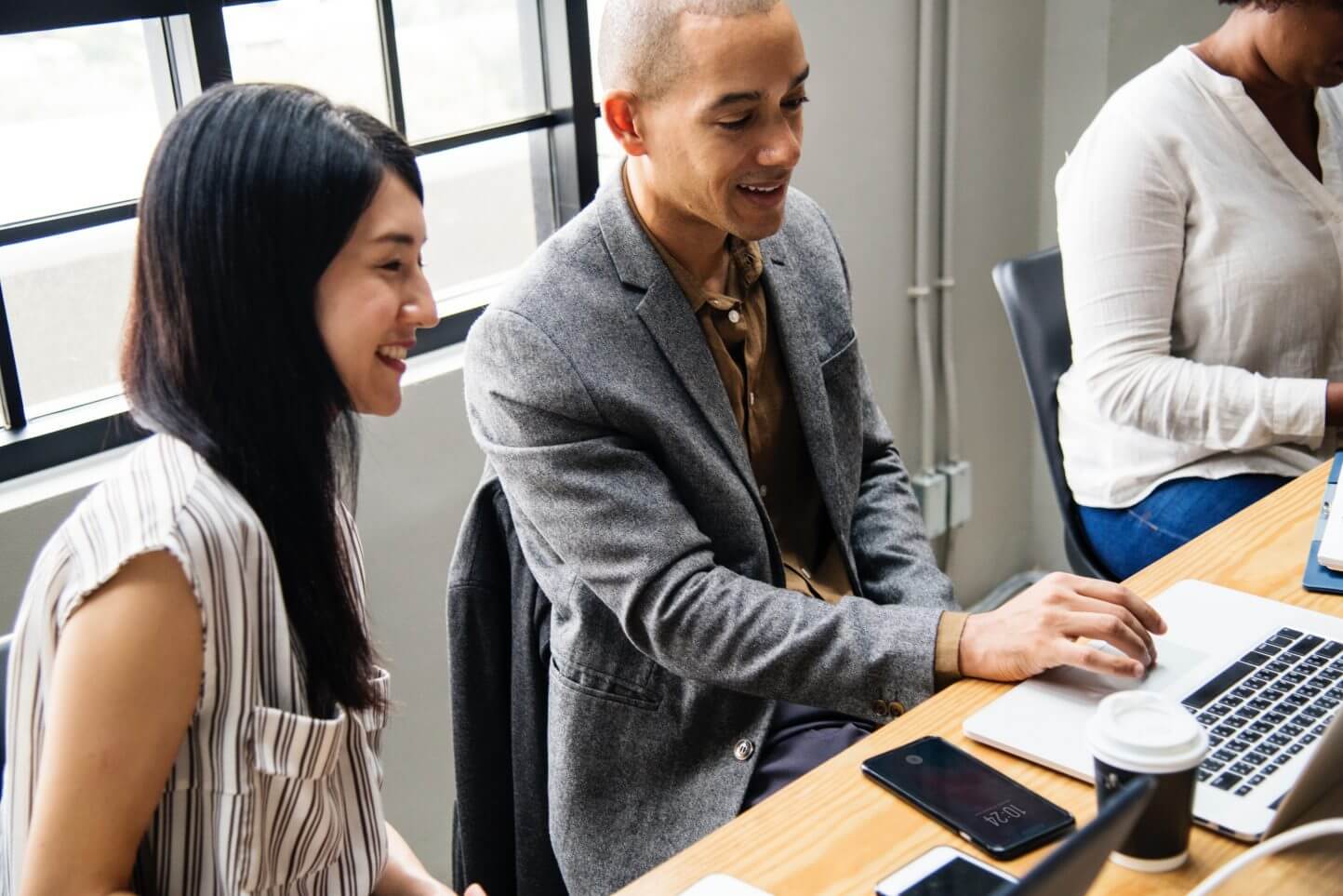 Two people at work, with a laptop