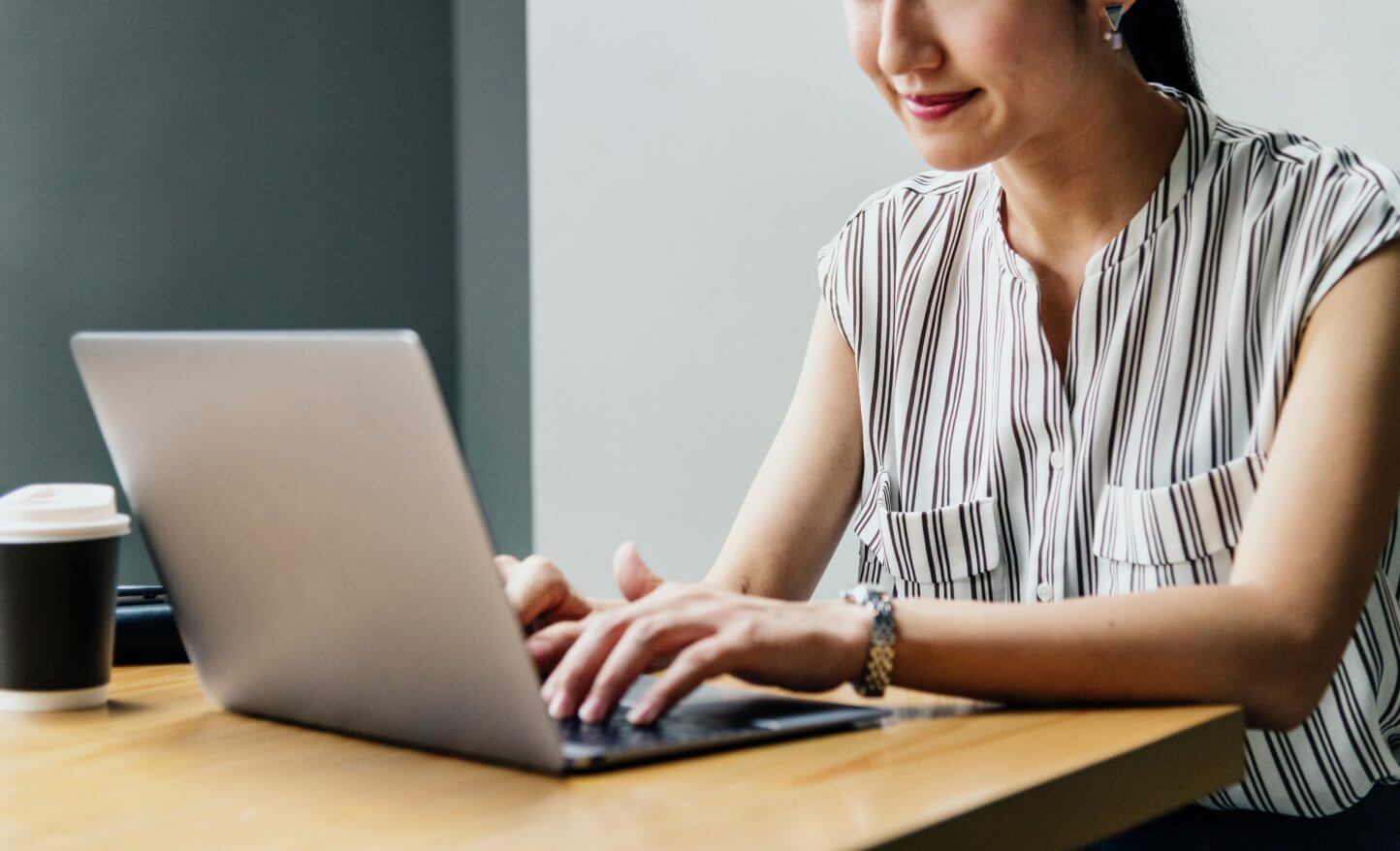 Woman typing on a laptop