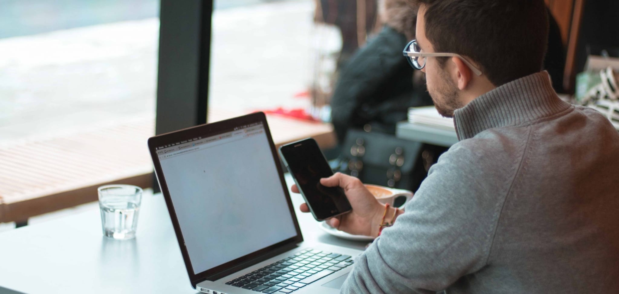 Man with his cell phone and laptop