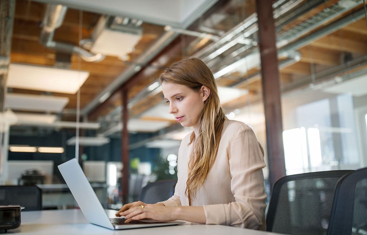 A woman typing on a laptop