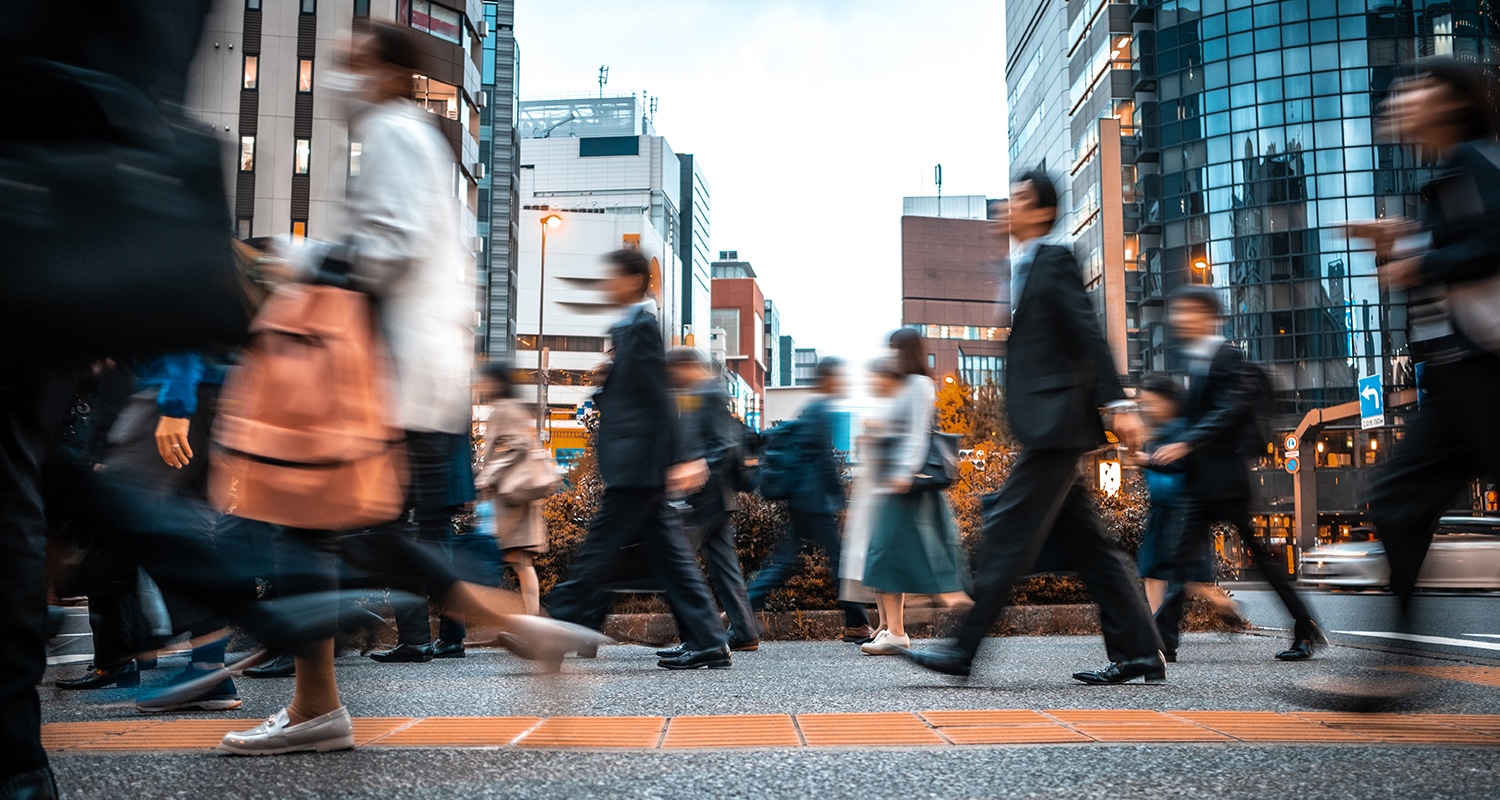 many people walking on the street , buildings